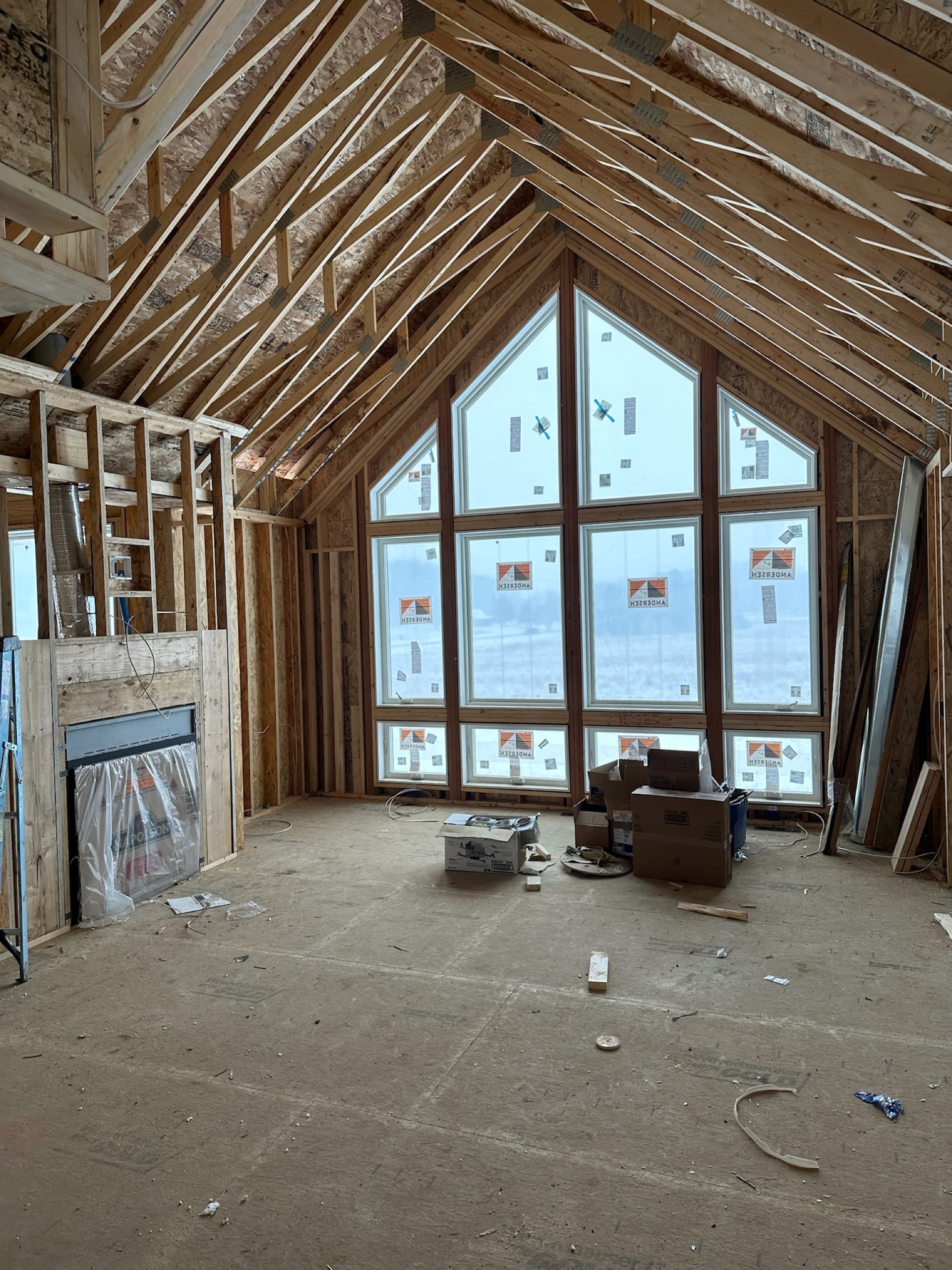 Cathedral great room framing with full window wall and fireplace