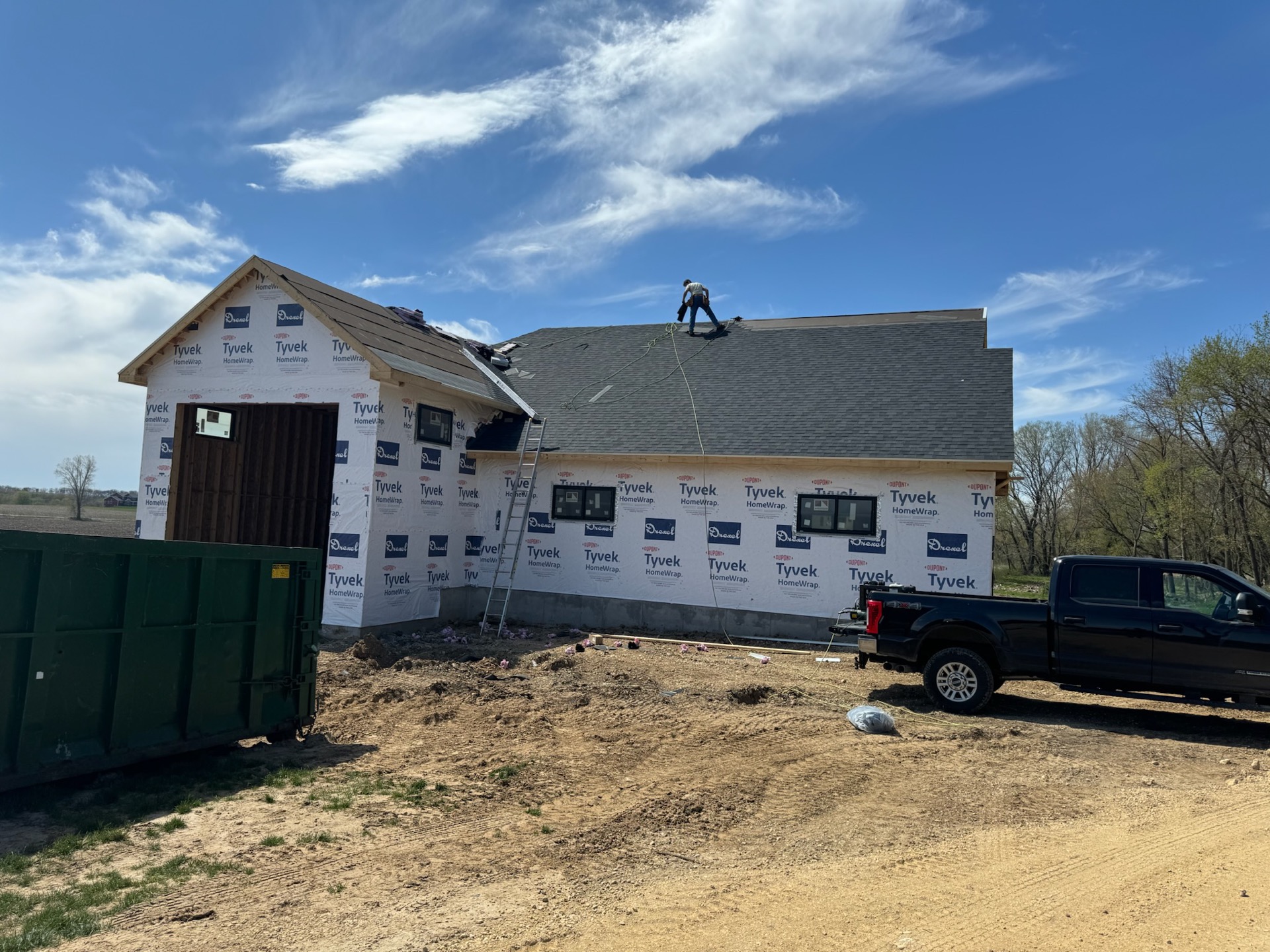 Framer on roof under blue sky