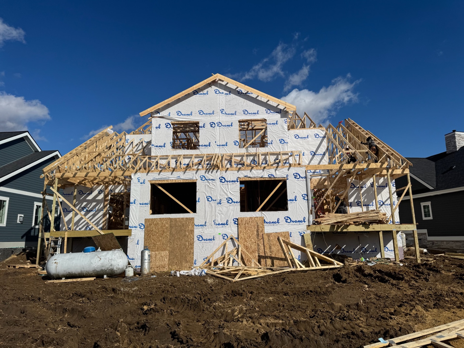Open roof trusses framing against blue sky