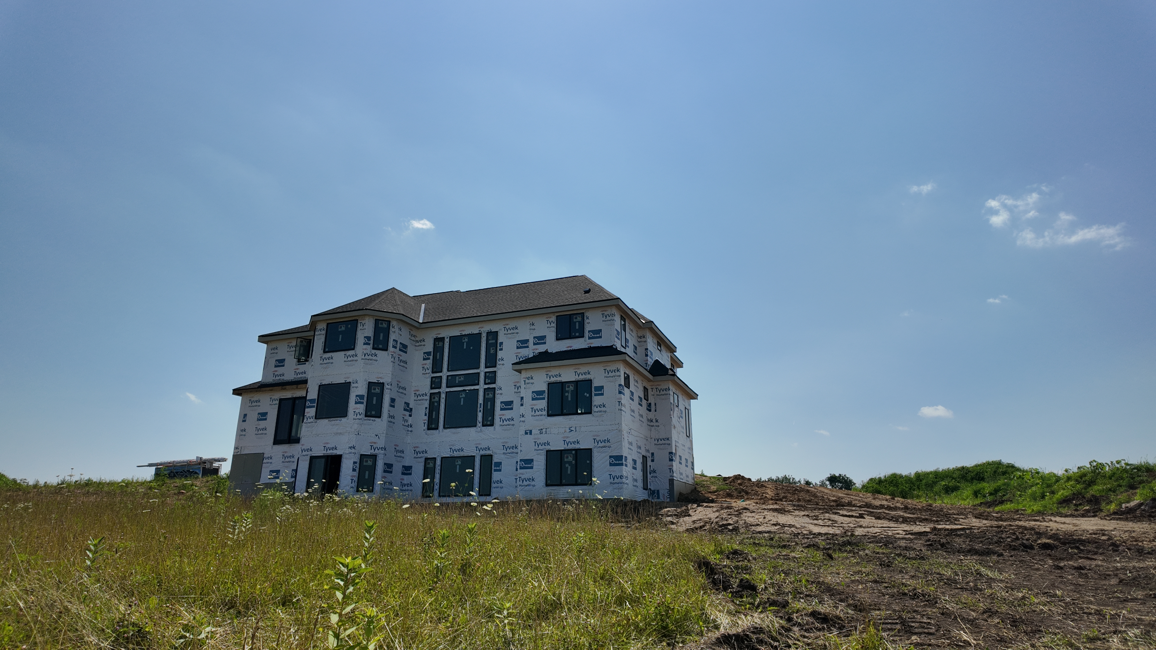 Luxury custom home under construction on a hilltop